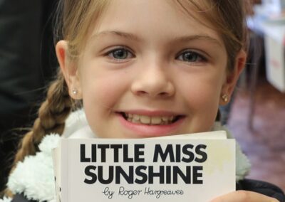 girl holding little miss sunshine book_featured image