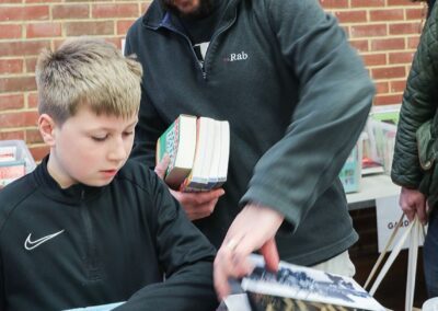 man and boy with books